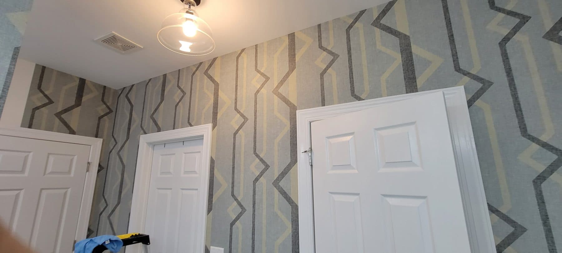Geometric wallpaper in an upstairs hall